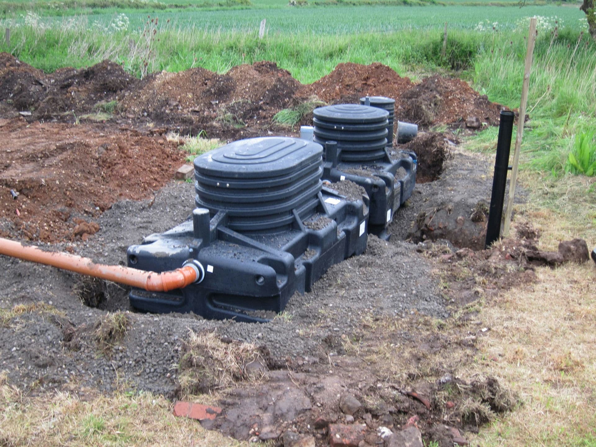 The primary tank (foreground) and the BIOROCK tank with dry-mix concrete back-fill. The inlet pipe (left of shot) is just temporary to permit the tanks to be partially filled to balance the pressure of the back-fill.